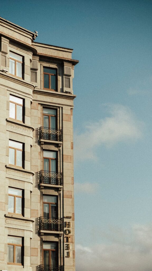 Side view of a historic hotel building with classic architecture against a clear sky.